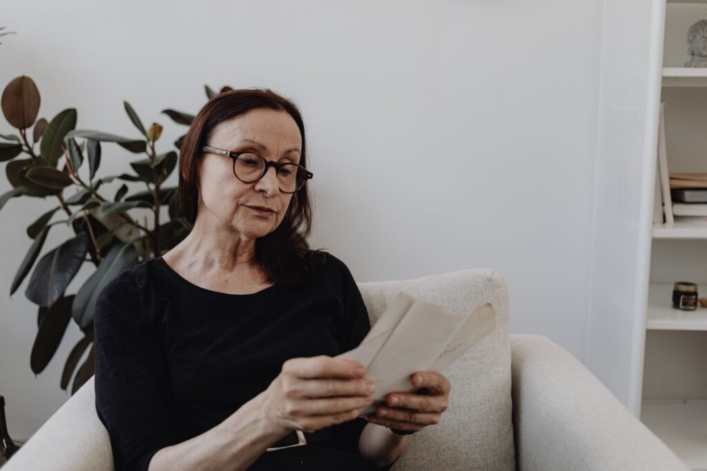 A Medicare beneficiary reading her plan's Annual Notice of Change letter at home