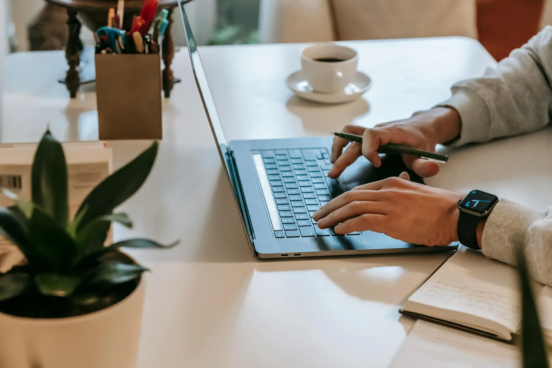 Self-employed worker reviewing finances on a laptop with paperwork on the desk