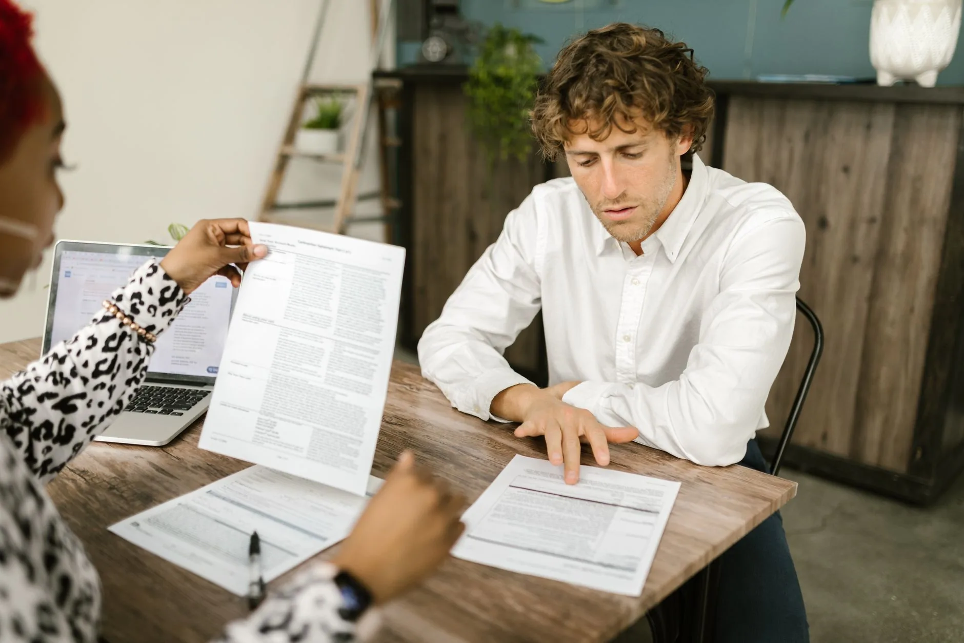 A business owner and accountant reviewing financial statements together at a desk
