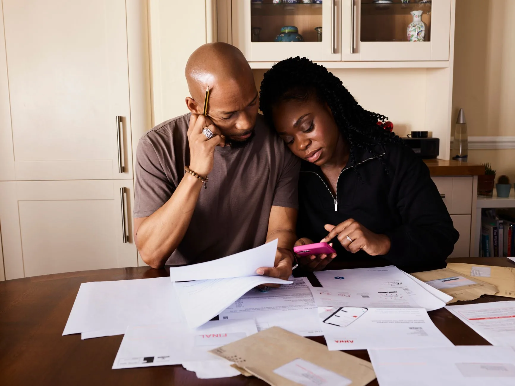 A family reviewing financial and tax documents together at a kitchen table