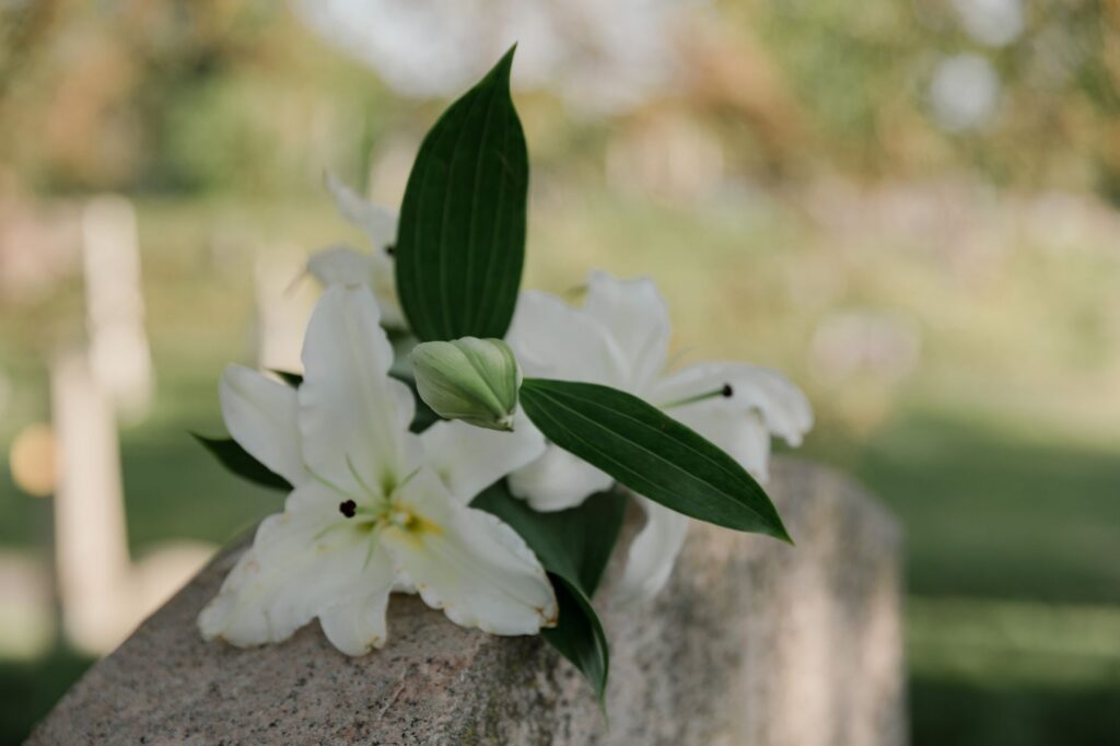 White lilies and a memorial candle
