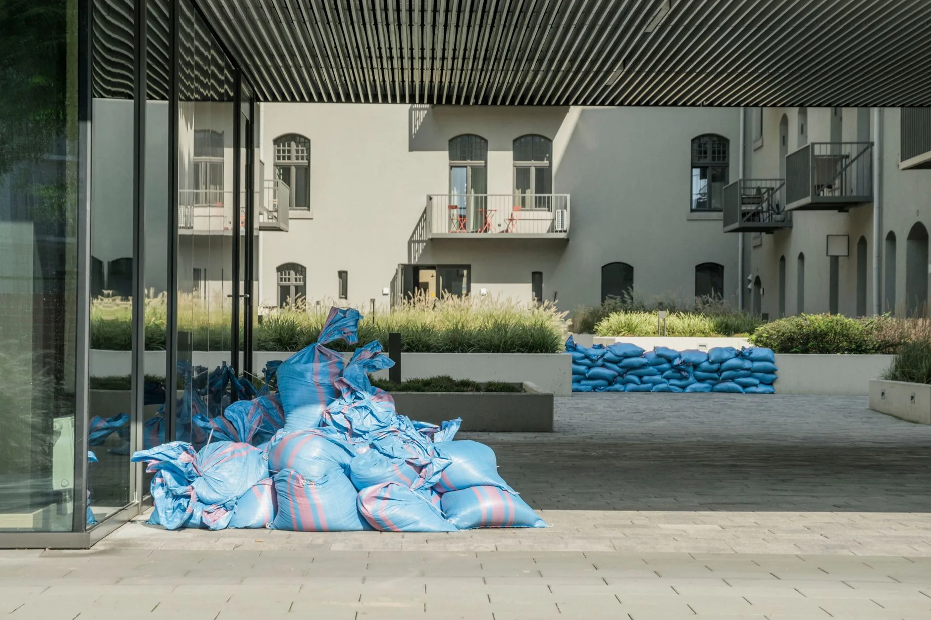 Sandbags stacked at a home's doorway to hold back flood water